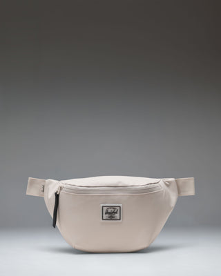 Herschel Supply Co. Pop Quiz Hip Pack in Moonbeam Tonal. A clean, minimalist beige fanny pack with a waterproof zipper and front pocket.