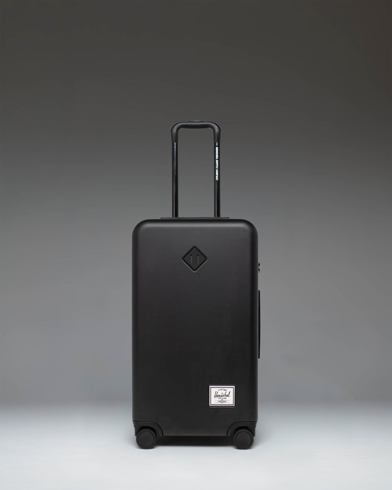 Black Herschel Heritage Hardshell Medium Luggage in black, front view.