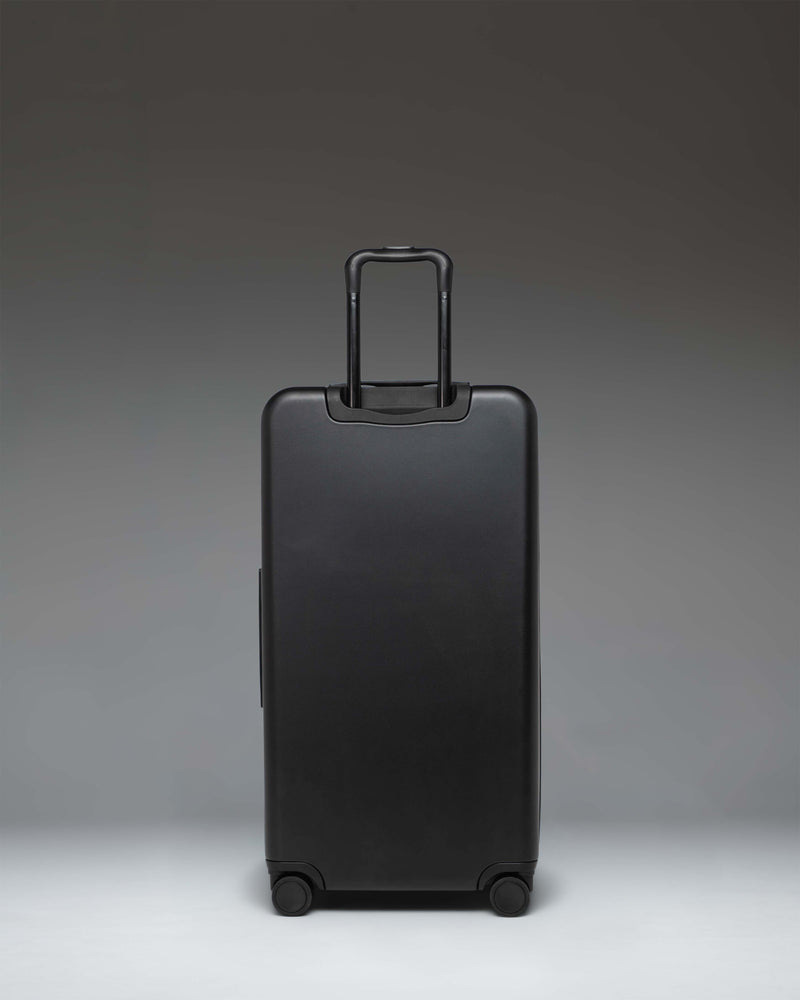 Black Herschel Heritage Hardshell Large Luggage suitcase.