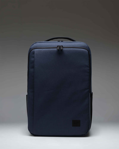 Herschel Supply Co. Kaslo Backpack Tech in Mood Indigo, showing the front view with zipper compartments and adjustable shoulder straps.