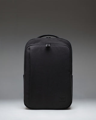 Black Herschel Supply Co. Kaslo Daypack Tech backpack viewed from the front, showcasing its clean design, dual top handles, and zippered pockets.