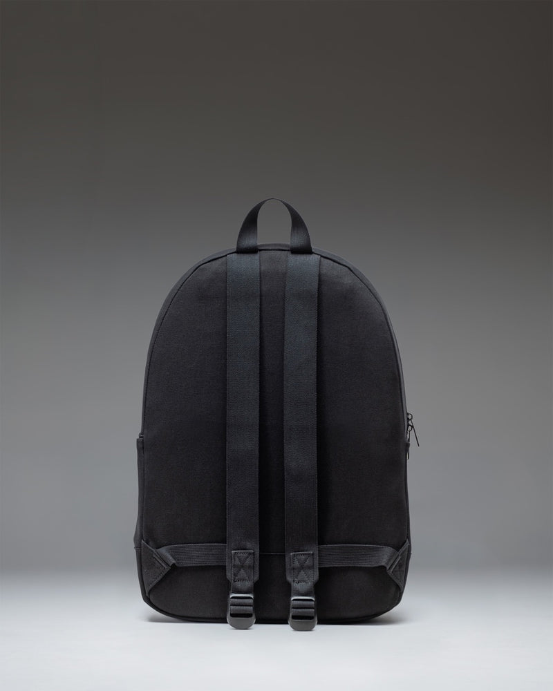 Herschel Supply Co. Pacific Daypack in solid black, showing the classic everyday backpack design with adjustable shoulder straps and front pocket.