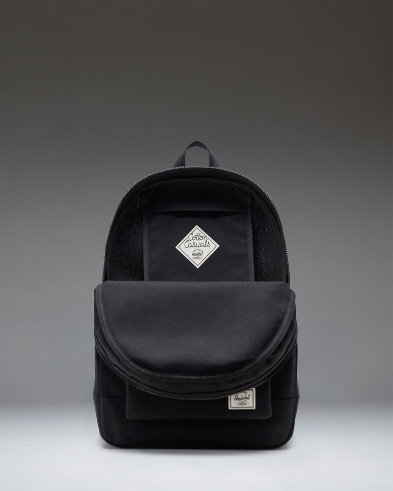 A classic Herschel Supply Co. Pacific Daypack in solid black, showcasing its clean design and durable fabric.