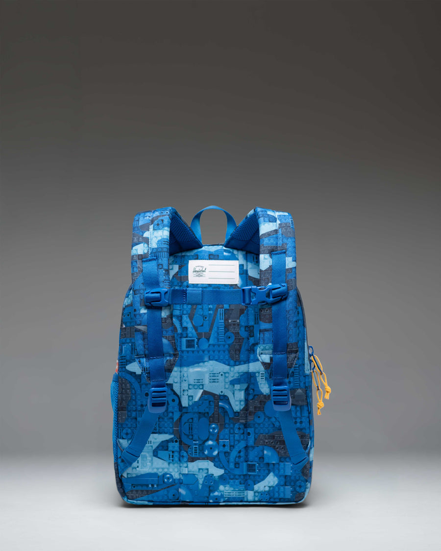 LEGO Herschel Heritage Kids Backpack in Abstract Bricks Blue featuring a colorful LEGO brick pattern with adjustable straps.