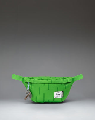 Herschel Supply Co. Minecraft Classic Hip Pack in The Overworld print, featuring a pixelated green and blue landscape design.
