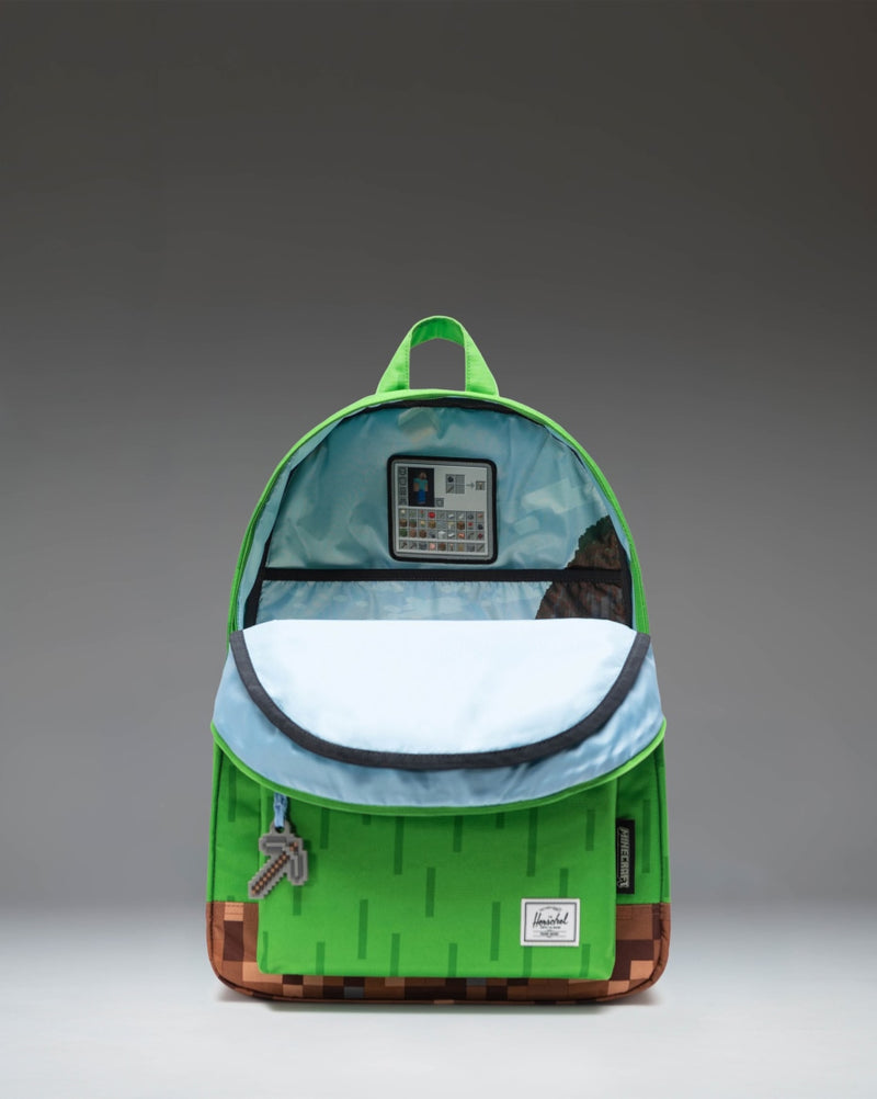 Herschel Supply Co. x Minecraft Classic XL Backpack in The Overworld print featuring pixelated green and blue blocks with iconic game graphics.