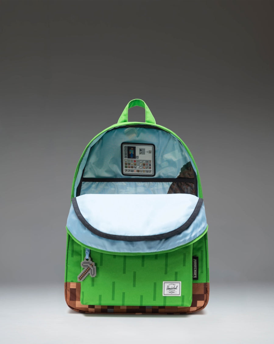 Herschel Supply Co. x Minecraft Classic XL Backpack in The Overworld print featuring pixelated green and blue blocks with iconic game graphics.
