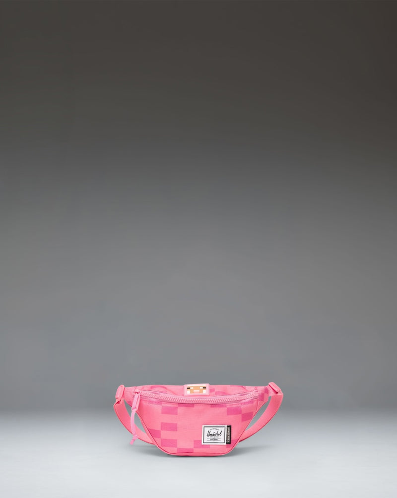 Pink Herschel Supply Co. x Minecraft Heritage Hip Pack with a pixelated Pink Sheep pattern and classic woven label.