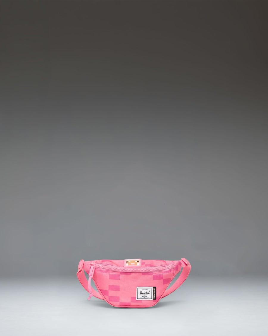 Pink Herschel Supply Co. x Minecraft Heritage Hip Pack with a pixelated Pink Sheep pattern and classic woven label.
