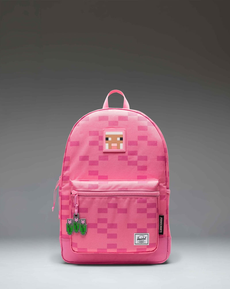 Herschel Supply Co. Minecraft Heritage Youth Backpack in Pink Sheep, featuring a pixelated pink Minecraft sheep print design.