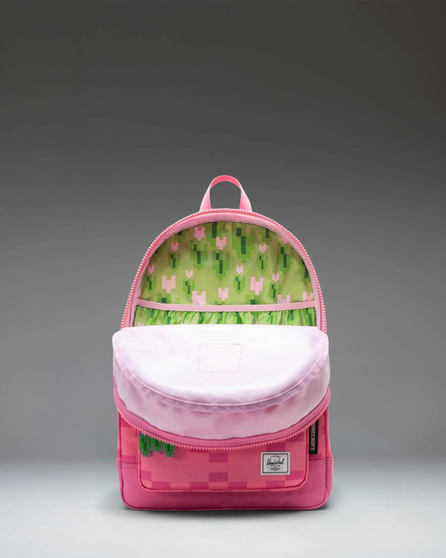 Herschel Supply Co. Minecraft Heritage Youth Backpack in Pink Sheep featuring pixelated blocks and character design.