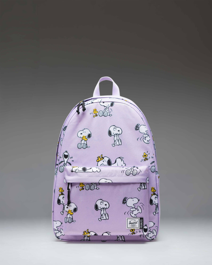 Herschel Classic XL Backpack in Peanuts Snoopy and Woodstock Pastel Lilac, featuring an all-over character print on a light purple background.