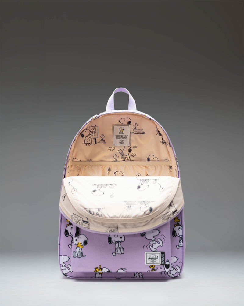 Herschel Supply Co. Peanuts Classic XL Backpack in Snoopy and Woodstock Pastel Lilac showing the front view with zippered pocket.