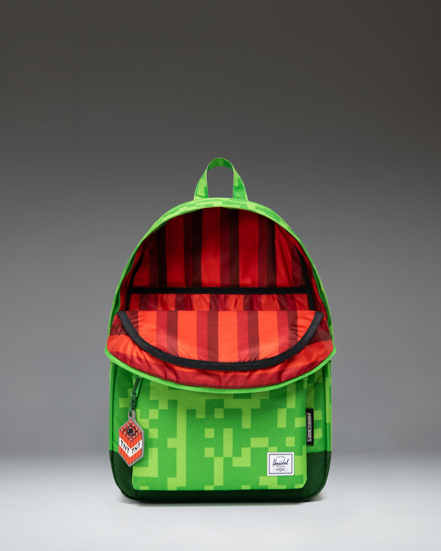 Herschel Supply Co. x Minecraft limited-edition Heritage Youth backpack in the pixelated green Creeper pattern.