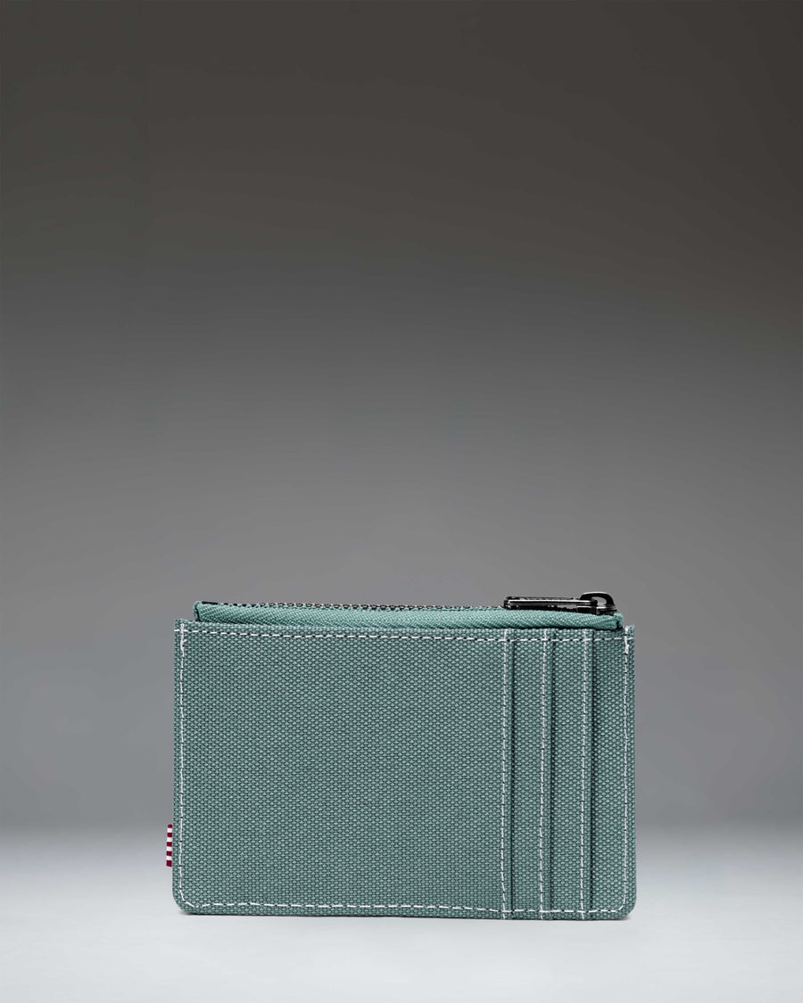 Black Oscar Cardholder wallet with a white Herschel logo tag sown at the front.
