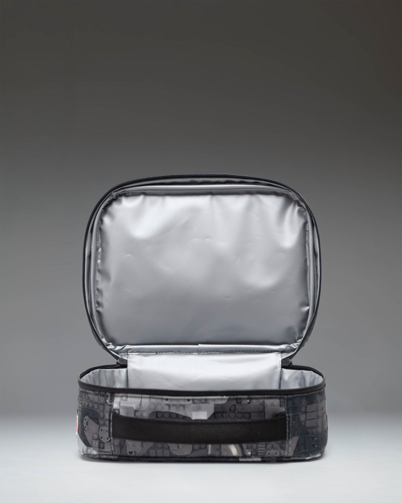 Herschel Supply Co. LEGO Pop Quiz Lunch Box in Abstract Bricks Black, showing the insulated interior and mesh pocket.