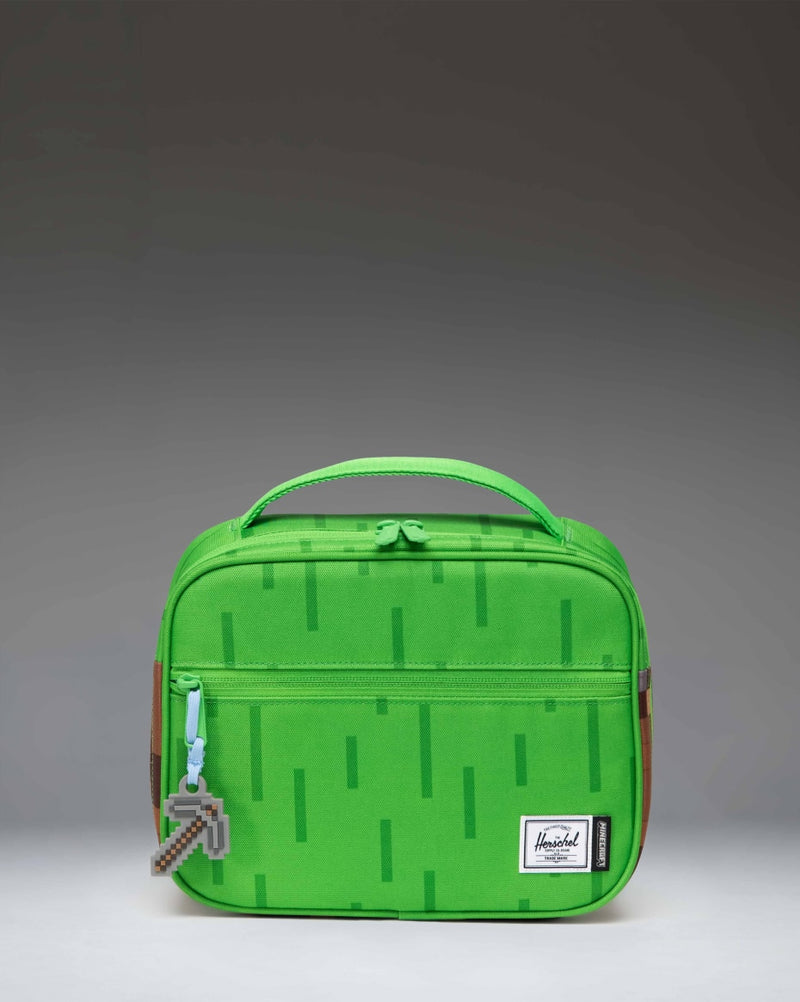 Herschel Supply Co. Minecraft Pop Quiz Lunch Box in The Overworld print, featuring a pixelated green and blue terrain design.