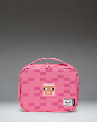 Herschel Supply Co. Minecraft Pop Quiz Lunch Box in Pink Sheep, featuring a pixelated pink design with a front zippered pocket.
