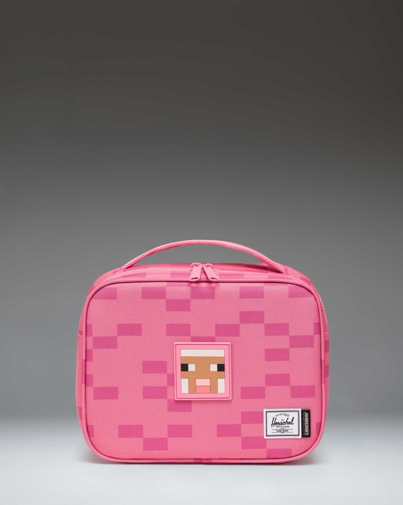 Herschel Supply Co. Minecraft Pop Quiz Lunch Box in Pink Sheep, featuring a pixelated pink design with a front zippered pocket.