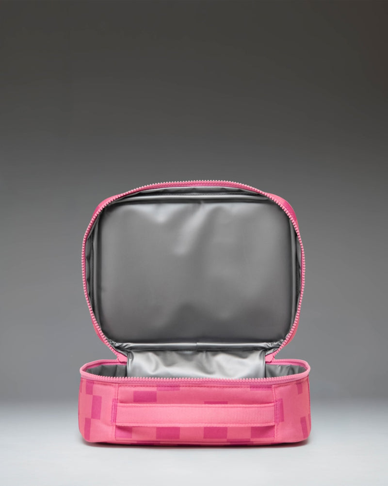 Pink Minecraft Pink Sheep lunch box by Herschel Supply Co. featuring a pixelated sheep pattern and front storage pocket.
