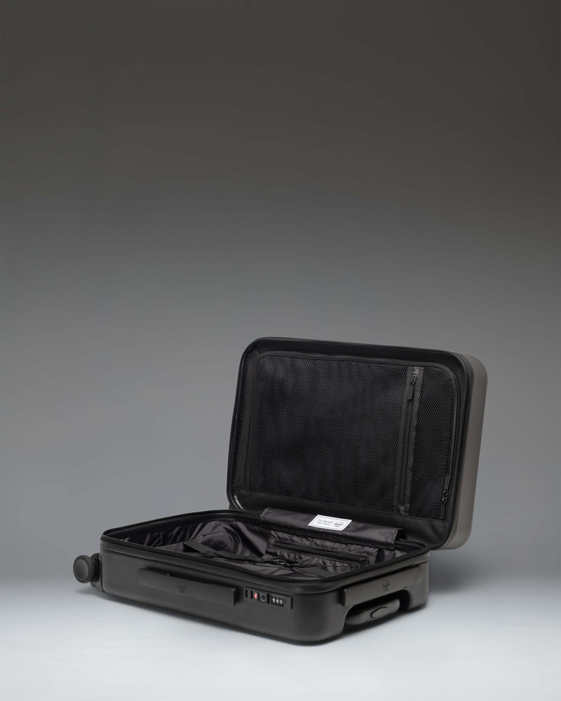 Herschel Heritage Hardshell Pro Large Carry On luggage in black, showcasing a side profile view.
