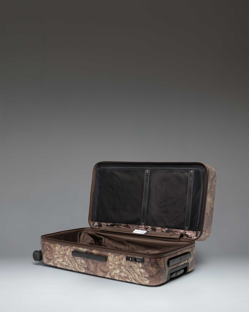 Herschel Heritage Large Luggage in Realtree APX Camo, showing a close-up detail of the durable fabric and zipper closure.