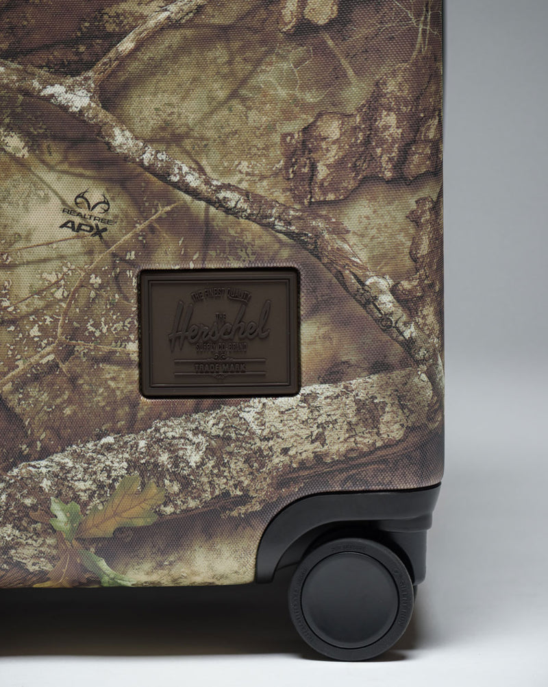 Herschel Heritage Large Luggage in Realtree APX Camo camouflage pattern.