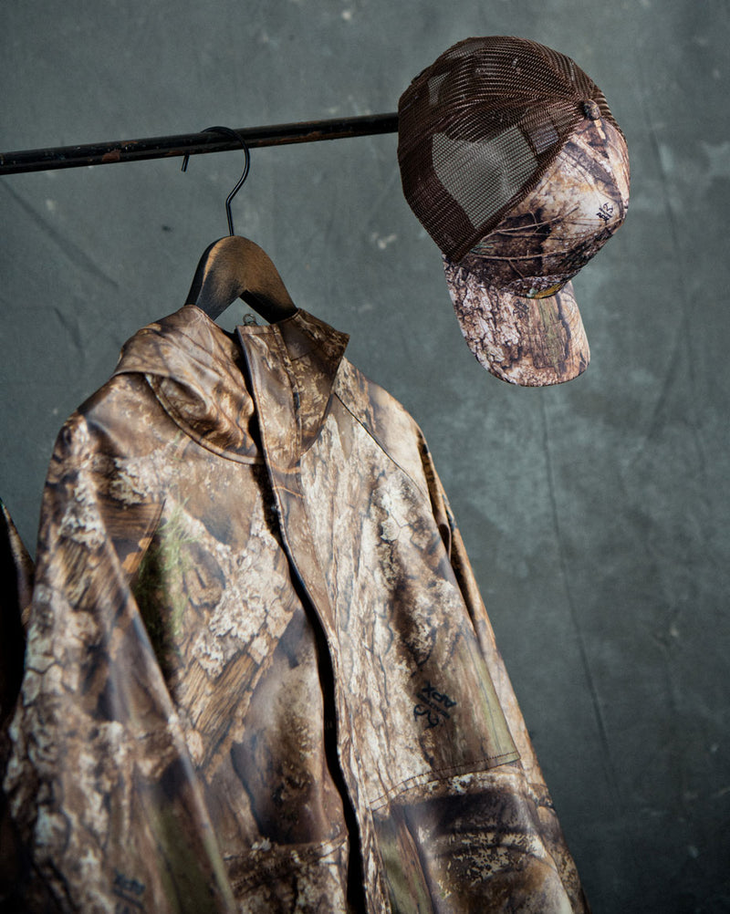 Men's Herschel Supply Co. Realtree Classic Rain Jacket in Realtree APX Camo pattern.