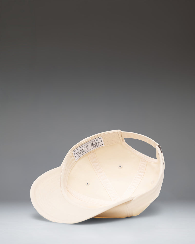 Herschel Supply Co Sylas Vintage Cotton Cap in Vintage White, shown from the side.