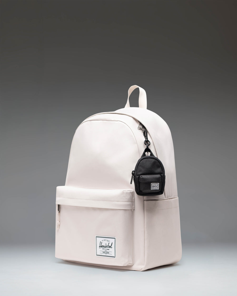 Herschel Classic Backpack Bag Charm in black, showing its compact design and zipper details.