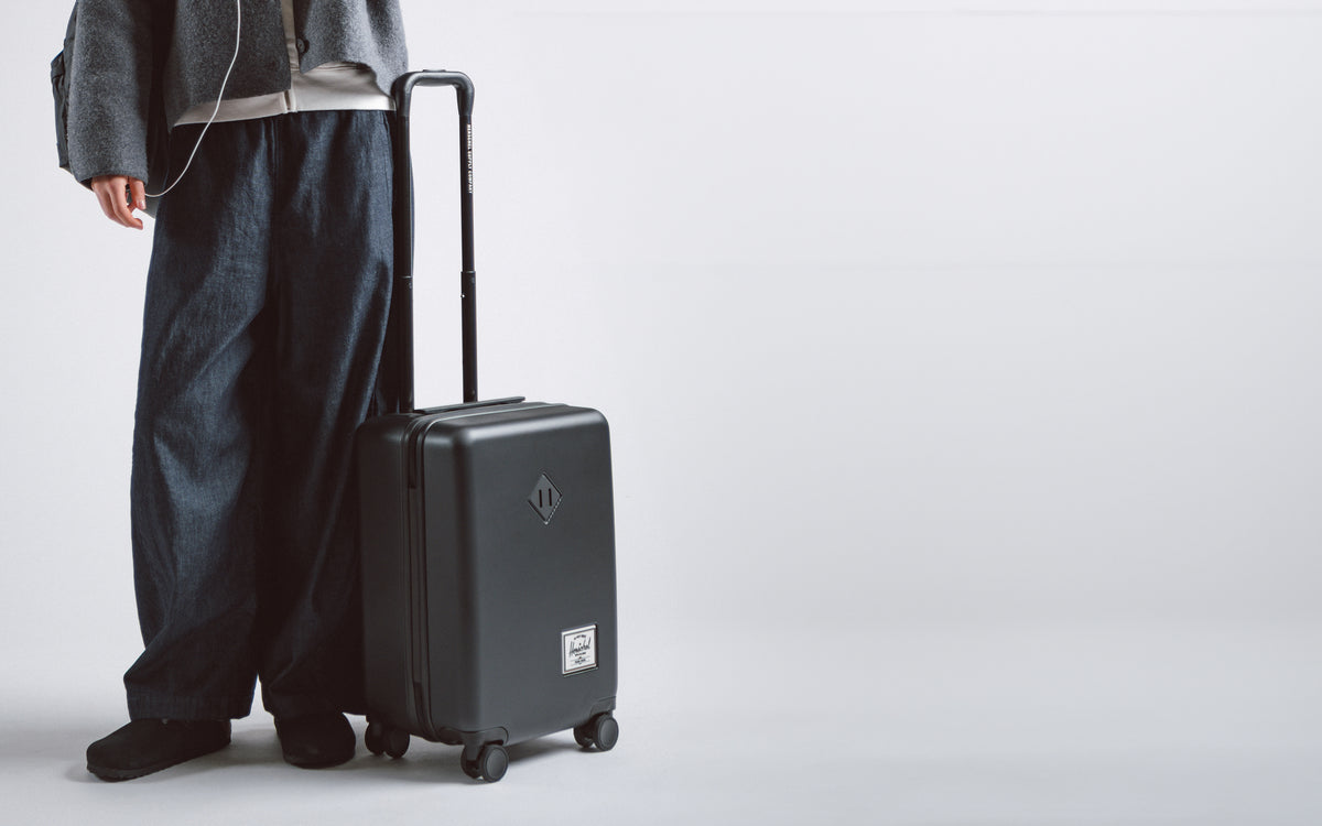 Herschel Heritage Hardshell Carry On Luggage in black, showing the durable exterior and sleek design.
