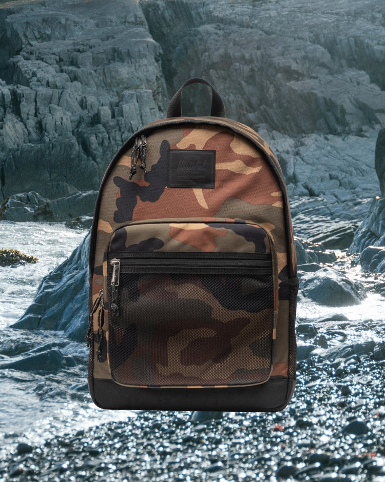 Herschel Supply Co. Kaine Backpack featuring a woodland camo print with black accents.