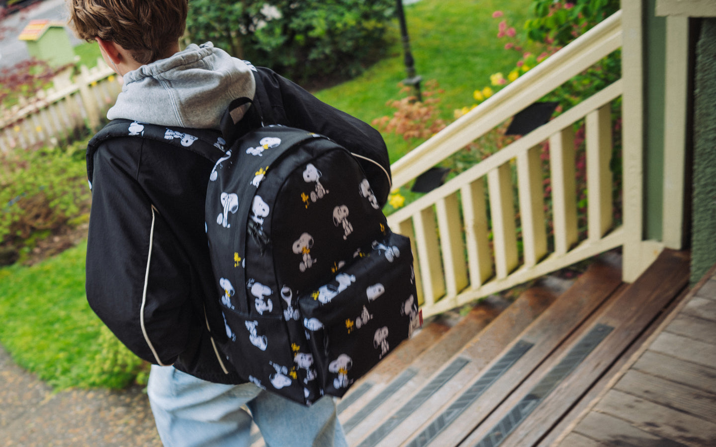 Herschel Supply Co. Peanuts Classic XL Backpack in Snoopy and Woodstock Black pattern shown on a desktop banner.