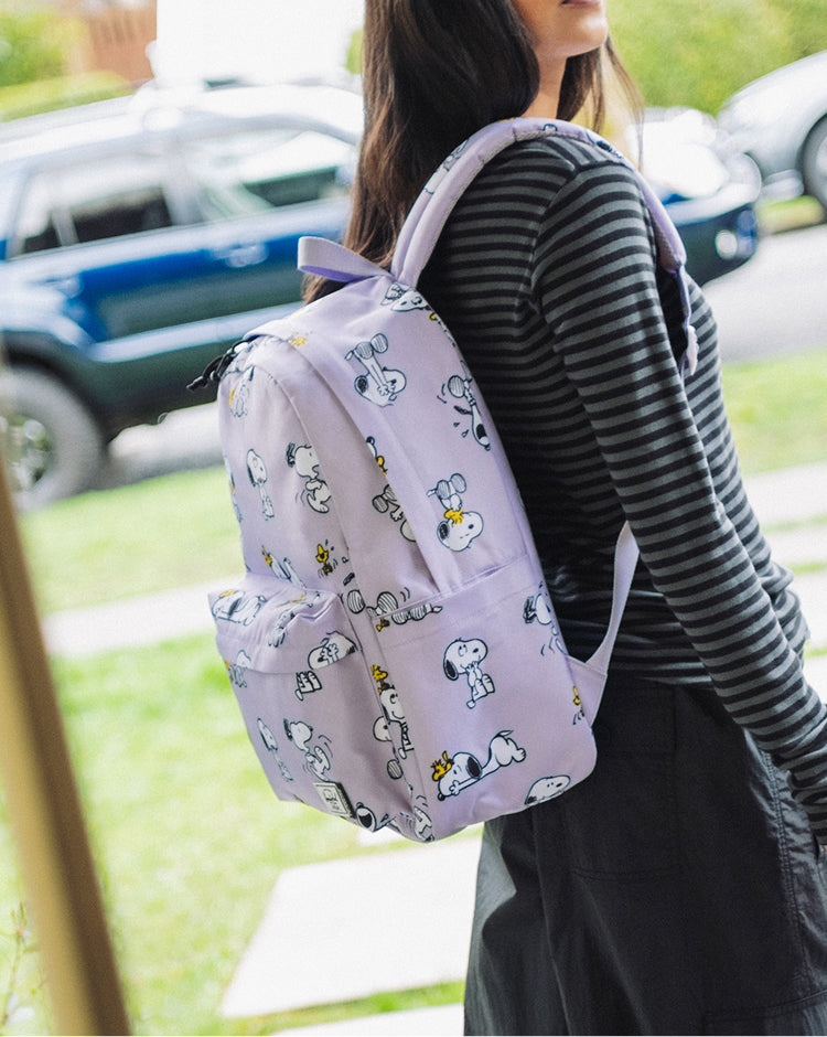 Herschel Supply Co. Peanuts Classic XL Backpack in Snoopy and Woodstock Pastel Lilac lifestyle hero image.