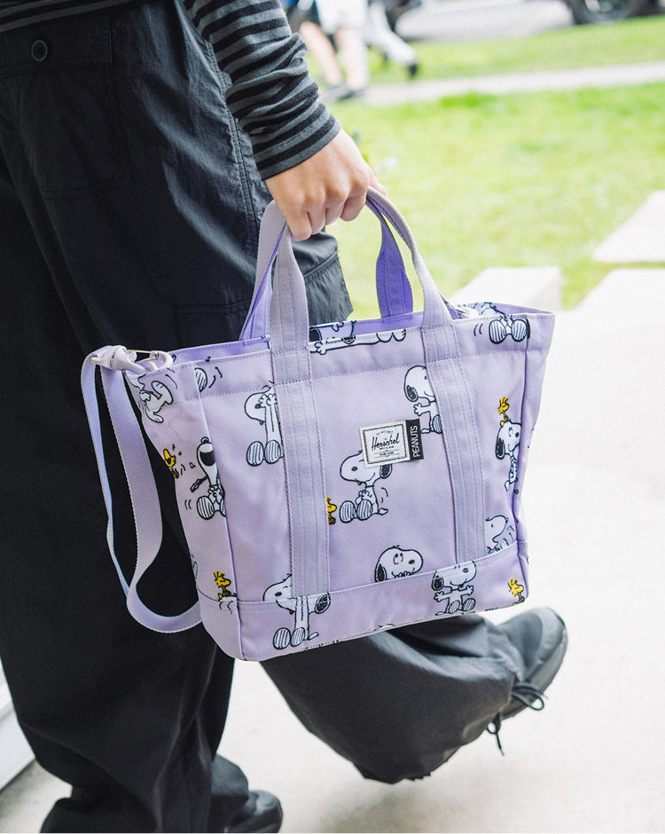 Herschel Supply Co. Peanuts Herschel Heritage Small Tote bag in Snoopy and Woodstock Pastel Lilac color.