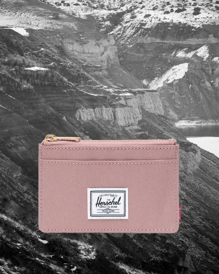 Herschel Supply Co. Oscar Cardholder in Ash Rose pink, a compact minimalist wallet featuring multiple card slots.