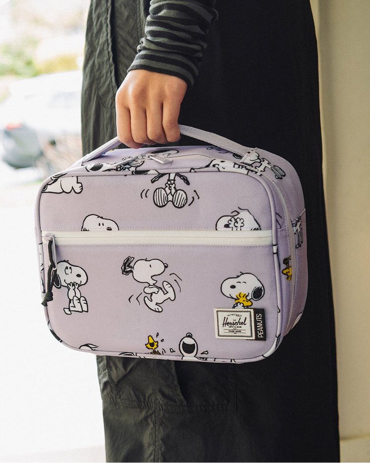 Herschel Supply Co. Peanuts Pop Quiz Lunch Box in Snoopy and Woodstock Pastel Lilac showing the front view.