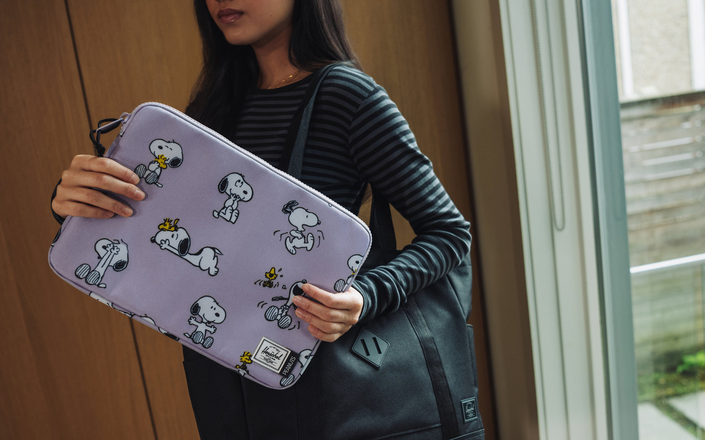 Herschel Supply Co. Peanuts Anchor 14 Inch Laptop Sleeve in Snoopy and Woodstock Pastel Lilac featuring a playful Peanuts graphic.
