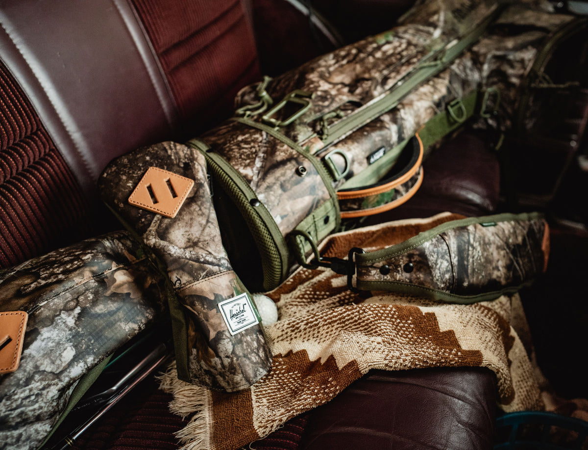 Herschel Supply Co. Realtree Heritage Fairway Wood Head Cover in Realtree APX Camo pattern displayed against a neutral background.