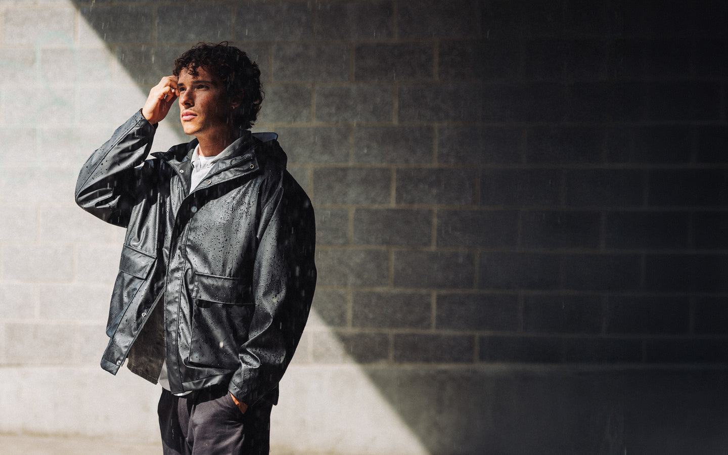 Herschel Supply Co. McLeod Rain Jacket Men's in Black, showcasing a classic waterproof design suitable for everyday wear.
